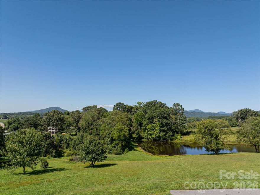One of only three coveted pond-front homesites in the upscale community of The Farm at Mills River, offering breathtaking long-range mountain views and unforgettable sunsets. With gentle topography and easy buildability, this property provides the perfect canvas for your dream home. This beautiful homesite offers a peaceful, pastoral setting with a charming working cattle farm nearby.  Enjoy the serene sights of open fields and grazing cows, which add to the property's authentic countryside character. Enjoy the convenience of city water, sewer, natural gas, and high-speed fiber-optic internet, which are rare features in such a serene, picturesque setting. The community is thoughtfully designed with wide, easy roads ideal for walking or biking, and amenities that include a charming gathering space, a fishing and floating pond, and a small beach and picnic area. Ideally located in Mills River, this property offers quick access to both Asheville and Hendersonville, as well as close proximity to Asheville Regional Airport, making travel effortless. Reasonable HOA fees add to the appeal of this beautiful, well-appointed neighborhood. Don't miss this rare opportunity to secure a beautiful lot in a highly desirable mountain community.