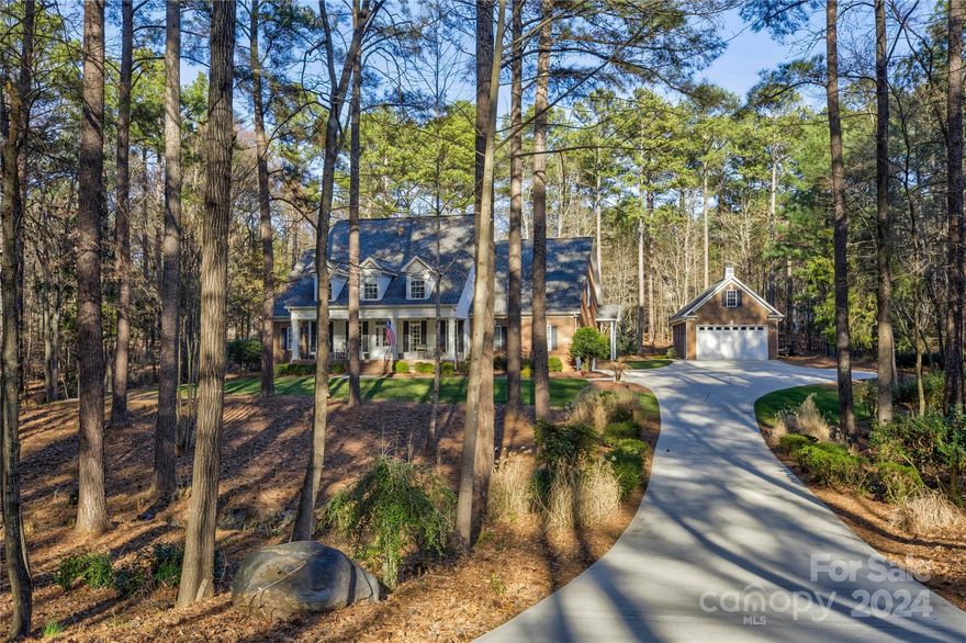 Nestled in the coveted Water Edge community on Lake Wylie, this rare gem boasts a double lot (1.75+ acres), offering subdivision potential. Ebenezer Park's amenities are conveniently located nearby, featuring a sandy beach, boat launch, concert venue, and camping sites just over one mile away. Meticulously maintained, this 4,170 sqft residence offers 5 beds, 3.5 baths, a sunroom, bonus room, main level office, and a serene screened in porch. Hardwood floors grace the main level and updated counters put a modern touch on this gourmet kitchen. There is more than ample parking opportunity with an attached 3-car garage and oversized detached 2-car garage with storage above. For peace of mind, the property features a whole house generator and a fully encapsulated crawlspace, as well as all new HVAC on 1st floor in 2024. Discover lakeside living with room for plenty of cars/toys or possibly even boat storage!