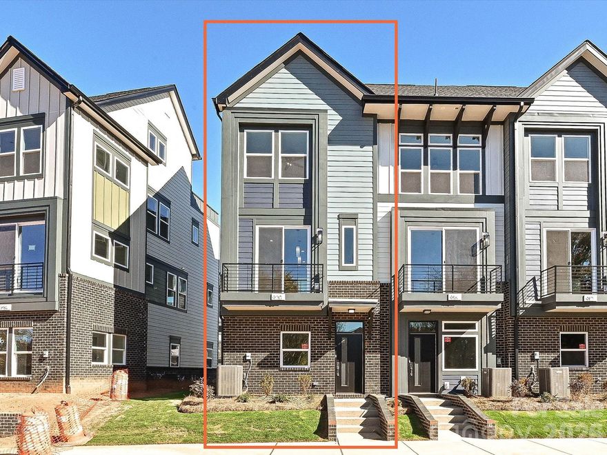 This end-unit townhome has it all - 1-car garage plus driveway parking, 1st floor flex room with powder, seasonal city skyline view from the kitchen terrace, 4th floor bed/bonus room with powder, & a spacious rooftop terrace.. Did we mention 9' ceilings throughout, and it's walking distance to Camp North End? Great open layout on the 2nd floor. Kitchen has 42" cabinets w/ matte black hardware, quartz counters, pantry cabinet, LED under-cabinet lights, trash pullout, large SS undermount sink, & GE SS app w/ gas range. 3rd floor hosts the laundry closet and both bedrooms. Premier bath includes quartz counters,  tiled floor, & tiled shower with semi-frameless glass. Guest bath has quartz counters and tiled floor. Matte black hardware in baths. LVP floors throughout 1st & 2nd floors & 3rd floor landing, with oak treads on all stairs.