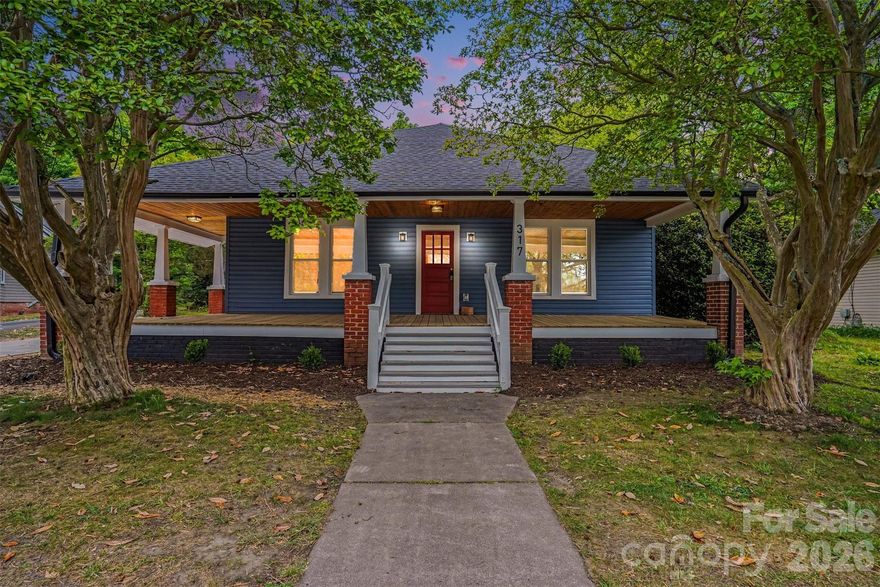 Welcome to 317 South Ridge Avenue—a fully renovated 4-bedroom, 2-bath home offering nearly 2,000 square feet of thoughtfully updated living space just a few minutes walk from downtown Kannapolis. Blending classic mill-town character with modern design and systems, this home delivers the benefits of new construction with the charm of an established neighborhood. Inside, you’ll find a bright, open layout where natural light flows from the private backyard through the spacious dining area into a new, beautifully redesigned kitchen. The kitchen features a large center island, quartz countertops, custom cabinetry, and new GE appliances—perfect for everyday living and entertaining. Primary and second bathrooms have been expanded and fully updated with modern finishes and stylish tile. Restored hardwood floors run throughout most of the home, complementing the clean, modern finishes. Providing added efficiency, durability, and peace of mind other major improvements include all new roof, siding, windows, HVAC/ductwork, basement/crawlspace encapsulation, new electrical, new plumbing, new insulation, and new hot-water heater. Outdoor living is equally impressive, with a welcoming new front porch, a new concrete driveway, new rear deck, and new fenced backyard for privacy.  A standout feature is the renovated detached two-story outbuilding—ideal for a workshop, storage, or creative space, with a finished upper-level room perfect for an office or studio. Located within easy reach of downtown Kannapolis, including shopping, dining, parks, and commuter routes, this home offers a rare combination of size, quality, and location. Move-in ready with major systems already addressed—this is a property you don’t want to miss. Schedule your private showing today!