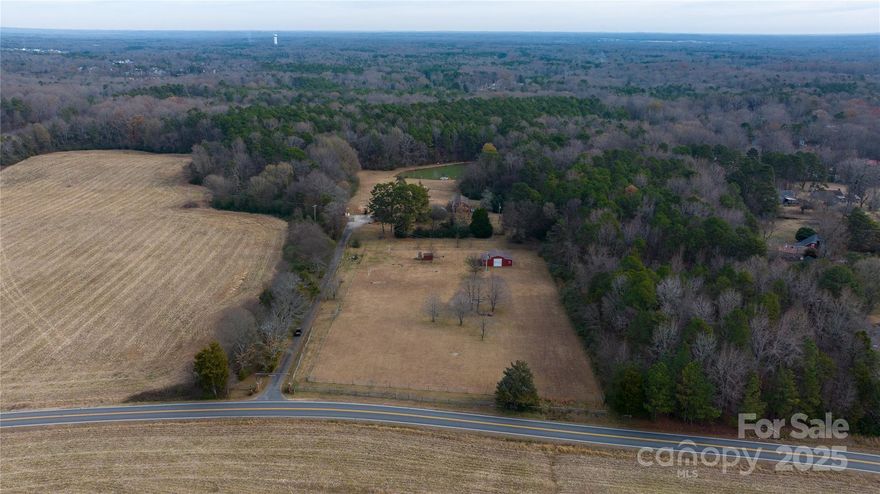 Just two miles off I-485, this 19.9-acre tract is located within the Charlotte city limits and offers a rare opportunity for development or long-term investment in a highly connected area of Mecklenburg County. Finding nearly 20 acres less than 15 miles from Uptown Charlotte is a rare find making this property a truly unique offering. Positioned along Allen Black Road, the site provides convenient access to major transportation corridors and strong connectivity to Uptown Charlotte as well as nearby growth markets including Monroe, Matthews, and Mint Hill.

The property features gently rolling topography, mature tree cover, fruit trees, and a scenic pond with a floating dock, adding natural appeal and flexibility for future site planning. The size, layout, and location allow for a wide range of potential uses, including a private estate, family compound, development, hobby farm, or long-term hold, subject to zoning and approvals.

The existing home is a 3-bedroom, 2.5-bath residence and is available for showings. Interior photos, video, and a full residential brochure, will be introduced separately under a residential MLS listing later in January. Please contact the listing agent for additional details regarding showings, access, or future residential listing information.

Per Mint Hill zoning, residential house setbacks are 60 ft from the front, 30 ft on the sides, and 50 ft from the back. Lot size needs 40,000 square feet, 70 feet of road frontage, and 140 ft lot width.