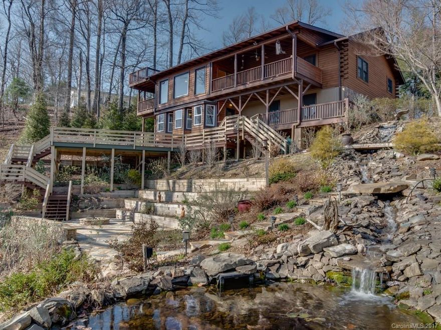 Experience nature from your back deck.  Outdoor living at its best.  Multi level decking, waterfall into Koi pond, stone fire pit and beautiful plants that the birds and butterflies enjoy.  Quality log construction, granite counters, built in sauna off the master bedroom, upper covered porches to take in the view.