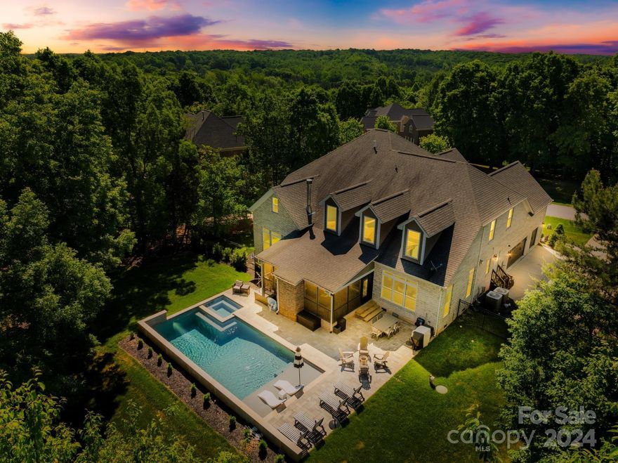 Welcome to this stunning 5-bedroom, 4.5-bath home in the sought-after Anniston subdivision. The spacious primary bedroom on the main floor features a luxurious jetted spa shower, his and hers custom closets, and Carrera marble vanities. The high-end kitchen boasts soft-close cabinets, quartz countertops, a farmhouse sink, a Butler’s Pantry, and a walk-in pantry with wood shelving. Enjoy the cozy real wood-burning fireplace in the breakfast area and the gas fireplace in the living room. Sliding doors lead to a large flagstone screen porch overlooking a serene, fenced-in backyard with a new pool and spa. Upstairs, a study area with built-ins with wine fridge, two bedrooms with a Jack-and-Jill bath, a bedroom with a private bath and walk-in closet, a bonus room with built-in shelves and a half bath, an extended bonus room area, and attic storage provide ample space. Additional features include a tankless water heater, extensive outdoor lighting, and an invisible fence.