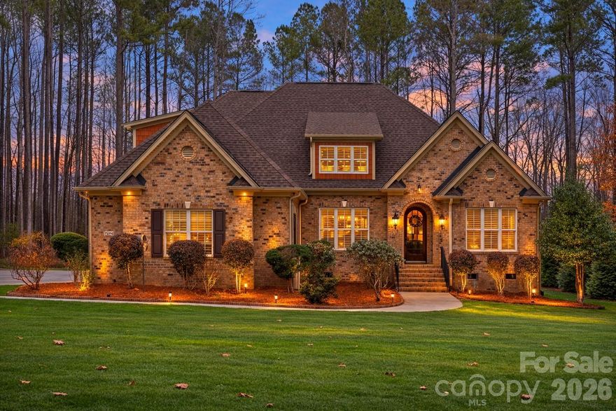 Tucked within the highly desirable gated community of Pebble Bay, this beautifully maintained residence offers privacy, elegance, and the relaxed lifestyle that makes Lake Norman living so special. Situated on a meticulously landscaped lot surrounded by mature trees, the home enjoys seasonal lake views and a peaceful setting that feels private while remaining conveniently close to everything.

Inside, the home welcomes you with warm hardwood floors, abundant natural light, and thoughtfully designed living spaces. The recently updated gourmet kitchen is a true centerpiece, featuring quartz countertops, custom cabinetry, high-end appliances, and elegant finishes that make it both functional and visually stunning. The kitchen flows seamlessly into the main living area where a beautiful stone fireplace creates an inviting space for gathering and entertaining.

The spacious primary suite is conveniently located on the main level, offering comfort, privacy, and ease of living. Additional living spaces provide flexibility for family, guests, or work-from-home needs.

One of the home’s most special features is the fully enclosed rear porch — a versatile space perfect for relaxing year-round, entertaining friends, or simply enjoying the quiet wooded surroundings.

Additional highlights include a desirable three-car garage, a beautifully manicured yard, and a private setting that enhances the peaceful atmosphere of the property.

Located just a short drive to Mooresville, Uptown Charlotte, major interstates, and Charlotte Douglas International Airport, this home combines the tranquility of Pebble Bay with exceptional convenience.

This is a rare opportunity to enjoy refined living in one of Lake Norman’s most sought-after gated communities.