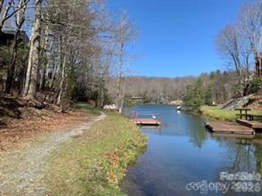 Lovely wooded lot facing Lake Tiaroga. This lot has a gentle slope perfect for building your Dream Home. It has a great location close to the Clubhouse and many amenities. These include 4 lakes, pickleball and tennis courts, swimming pool, hiking trails wellness center and more! This corner lot also has community water and sewer for your building convenience. Come take a look and discover the breathtaking views and welcoming Community of Connestee Falls!