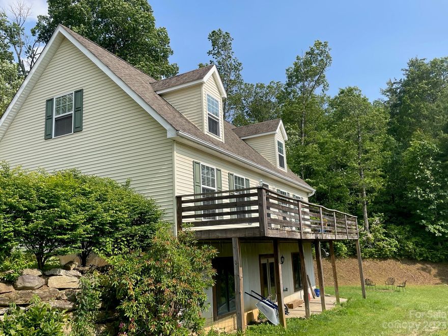 If your looking for privacy and a home that adjoins the Pisgah National Forest well here it is!  This homes sits on .96 acres at the end of the road. Hiking, biking, fishing are all literally in your backyard. This cape cod home features wood flooring, large master bedroom en-suite on main level with shower, garden tub and large walk-in closet.  The upper level has a spacious bedroom with large walk-in closet, a full bath and a bonus room to use as a den or office. The basement has superior concrete precast walls and is currently unfinished except for one room is now a playroom.  The storage in the basement is great or if you wish to finish it out it does have a separate entrance. Enjoy the endless year round mountain views from the front of the home.