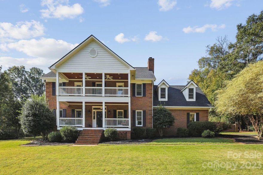 Meticulously Cared for Brick 2 Story Home on over 1 Acre.  Double Front Porches. Hardwood Floors on Main Level. Separate Formal Living and Dining Rooms w/ Decorative Moldings. Kitchen w/ Granite Countertops, Stainless Steel Appliances, Tile Back Splash, Under Cabinet Lighting opens up to Eat-in Breakfast Area, & Huge Walk in Pantry w/ Wood Shelving. Family Room w/ Built In Cabinets, Shelving, & Fireplace. Primary Bedroom w/ Ceiling Fan & Access to Upstairs Porch. Plush Primary Bathroom w/ Oversize Bathroom w/ Double Vanity, Free Standing Tub, Oversize Custom Tile Shower w/ Multiple Shower Heads. Huge Oversize Primary Closet w/ Custom Closet Organizers a Buyer will Love! Terrific Floored storage w/ Attic Pull-down. Rear Patio w/ Large Fenced Yard & Fire Pit. Freshly Painted 2 Car Side Load Garage. Great Location near Hwy 485 and within 10 minutes of Hwy 85, WT Harris, &  Concord Mills w/ Restaurants, Shopping. This is a Must See! You Won't Be Disappointed!