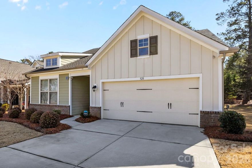 Welcome to this stunning 2021-built gem, perfectly situated on a prime corner lot in the desirable Rhyne Estates neighborhood. Meticulously maintained and freshly painted, this home offers a seamless blend of modern style and effortless functionality. The heart of the home is an expansive open-concept living area and a gourmet kitchen featuring 42" cabinetry, granite countertops, a large kitchen island, and a step-in pantry. The main-level primary suite is a true sanctuary with a walk-in closet and a spacious bathroom featuring a dual vanity and a zero-entry shower. Two additional main-floor bedrooms provide great flexibility for guests or an office. Upstairs, you'll find a private retreat with a spacious living room, a fourth bedroom, and a third full bath. Step outside to enjoy the screened-in porch and flat, fully fenced backyard, offering the perfect balance of privacy and room to play. This move-in-ready beauty is truly a must-see!