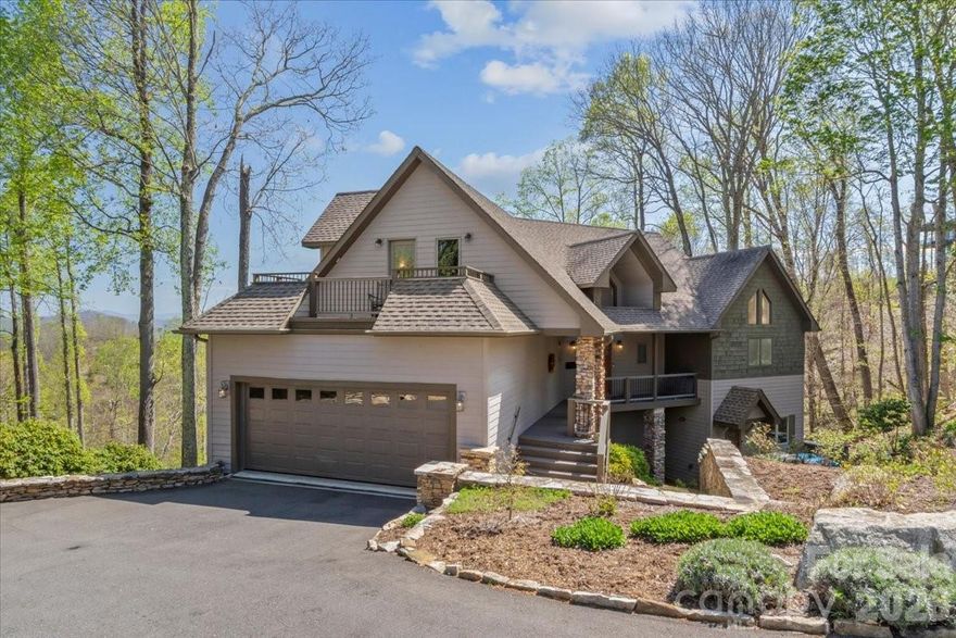 This beautifully updated custom home sits on over half an acre and offers breathtaking long-range mountain views in the peaceful and private Springhouse Drive neighborhood of MOUNTAIN AIR. Blending rustic charm with modern luxury, the wood and stone exterior is complemented by stone walls and a tranquil waterfall feature at the entry. Designed for ideal main-level living, the open floor plan includes a fully renovated kitchen with a handy pantry at your fingertips, plus a second pantry closet, a stylish powder room, a spacious dining area, and a great room with a soaring wood ceiling and a striking stone fireplace. The main level also features the primary suite with a luxury en suite bath and private laundry. The upper level offers a versatile guest suite or office with its own full bath and private deck—perfect for visitors or remote work. The expansive lower level is ideal for family or guests, with a large den, two bedrooms, two full baths, a kitchenette with additional laundry, multiple porches, and a private entrance. Offered furnished with a few seller exceptions. A newer electric golf cart is negotiable. Located close to the heart of the community and just a short distance from Club amenities—including dining, fitness center, tennis courts, golf, and year-round events and activities, available with separate Club membership.