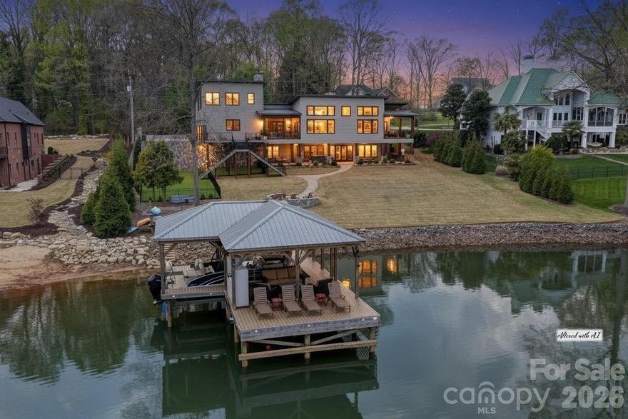 Experience luxury lake living in this custom Modern Craftsman home built in 2021, perfectly situated on a large lot in Mooresville with no HOA. Thoughtfully designed with exceptional craftsmanship and one-of-a-kind details, this home offers a truly elevated lifestyle. At the heart of the home is a grand chef’s kitchen featuring custom cabinetry and stunning black walnut accents milled directly from a tree on the property, showcased in the trim, floating shelves, range hood, and island. The adjoining family room continues the theme with custom walnut built-ins, creating a warm yet refined gathering space. Designed for flexibility and comfort, the home offers side by side, dual primary suites, each complete with a private bathroom, walk-in closet, and dedicated office area—ideal for multi-generational living or ultimate guest accommodations. The main primary suite also features a private covered and screened porch for a peaceful retreat. This home is an entertainer’s dream, highlighted by expansive sliding doors and a custom pass-through kitchen window that seamlessly connect indoor and outdoor living to a large screened porch with fireplace and an oversized deck. The walk-out basement is equally impressive, featuring two additional bedrooms with custom built-in bunk beds and private baths, a spacious living area, exercise room, and a must see, custom wine cellar. Step outside to enjoy the beautifully designed exterior, including a huge covered patio, custom fire-pit, and a fenced in, turf dog run. Just off the lower patio, you’ll find a large storage area perfect for all your lake gear and outdoor essentials. Waterfront living is complete with a newly built 1,000 sq ft covered dock and 7,000 lb boat lift, making this property ideal for enjoying Lake Norman to the fullest. With abundant storage, custom built-ins throughout, and unmatched attention to detail, this home is a rare opportunity in one of Mooresville’s most desirable locations.