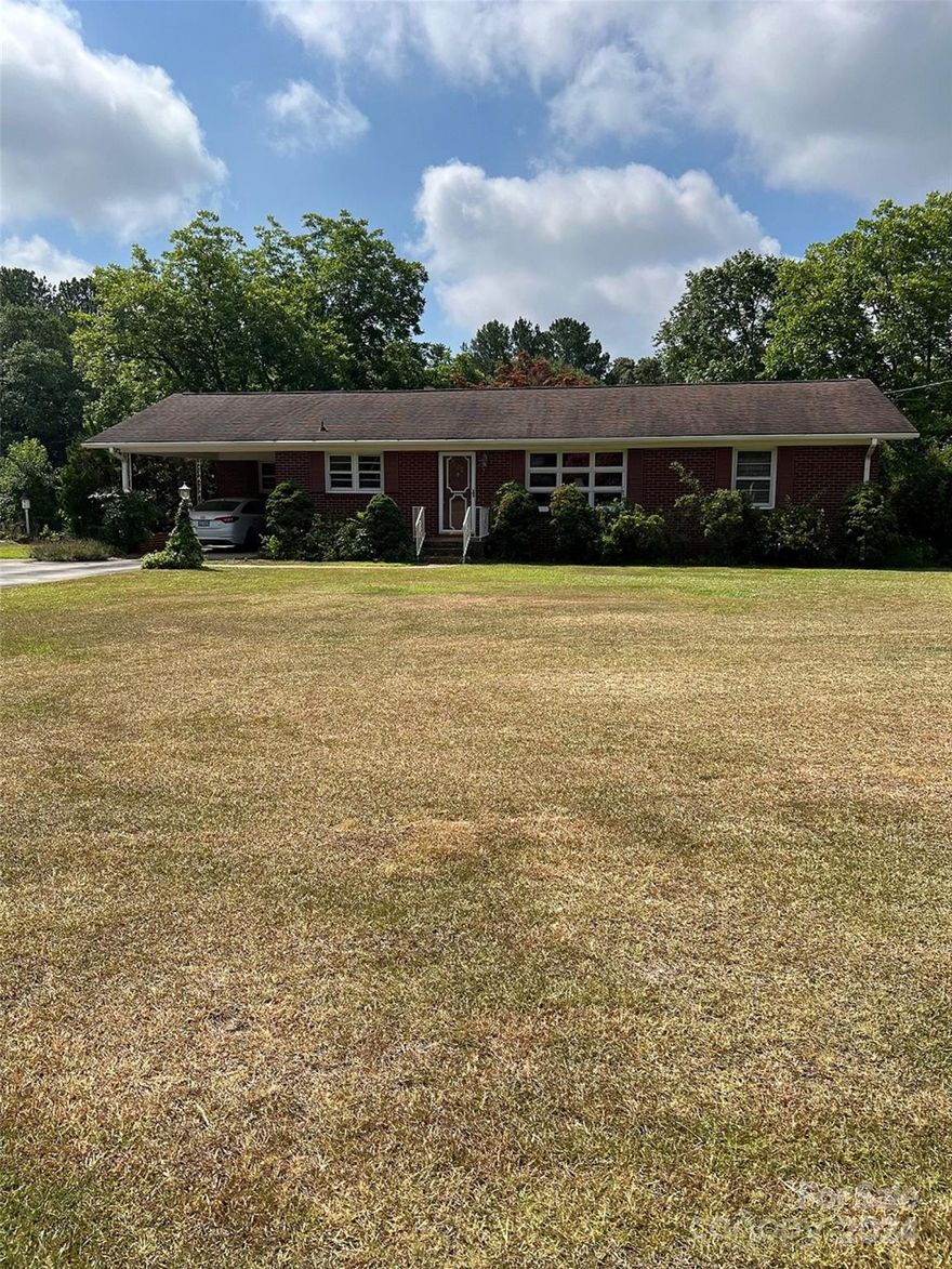 Here is what you have been looking for. Built in the 60's it needs some paint and updating but its quality can't be beat. Terrific potential. In a neighborhood but has lots of privacy. Only minutes to Lake Tillery, shopping and schools. An additional 2.07 acres is available that join this property.  Seller has listed as two 1.03 acre tracts at $29,900 each. They have water and sewer available.