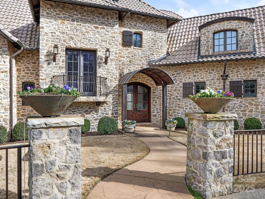 Welcome home to this exquisitely custom built solid stone Country French Chateau; Located in Seven Eagles, a gated and guarded community that resides in South Charlotte on the Quail Hollow Golf Course.  Built in 2001 from 8" Oklahoma stones, clay barrel roofing tiles, 10" cedar beams, solid mahogany interior stained doors,  solid wood stained garage doors, LED lighting in home, Open living and dining rooms with multiple sets of solid mahogany French doors, Rocky Mountain hardware on doors, 4 inch wood shutters on main floor living/dining/MB doors and windows. Kitchen, Scullery, Gathering(den), Powder, Dining, Living, Entry foyer, Master Suite on Main.  Elevator services all 3 floors. Upper floor has Library w built in cabinets, large seasonal closet, bedroom w built ins, bedroom en-suite, AND an Apartment Suite w separate interior and exterior entrance.  The apartment has kitchenette w sink, dw, u/c refrigerator, walk in closet, bath w shower and a separate stairwell from exterior.