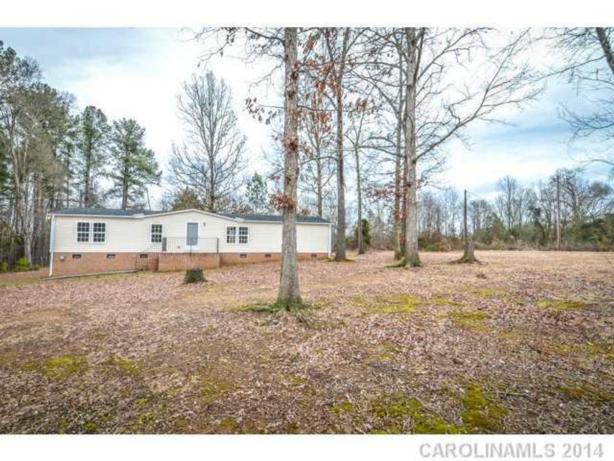 Immaculate 3BR/2BA double wide mobile home on almost 1 acre of land in Union County. This home features unexpected surprises - granite countertops, stone backsplash, maple cabinets, black appliances, double vanities and garden tub in master bath, upgraded laundry w/built in cabinetry, new flooring, fresh paint, new HVAC, new roof, front porch, back deck, brick surround, wooded acreage & more!