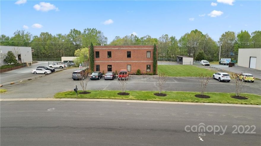 Commercial warehouse+abundant office space and land to add more sqft. Stellar location off Independence Blvd in Indian Trail! This unique multipurpose building offers a number of options for commercial up fit, sitting on 1.29 acres with extra green space to build on. 3000sqft warehouse has 16-20ft ceilings w/one drive-in garage door and one loading dock. Through the main office entrance there are two finished office spaces downstairs plus a full kitchen, conference room, and extra storage rooms. Downstairs also features laundry hook up and two separate half baths. Upstairs is plumbed for a small kitchen and has an open loft space, plus two additional enclosed rooms/office space and full bath. The warehouse is heated by Space-Ray Infrared gas heater. Behind the building are two double-gate entrances to the fully fenced lot. Two additional covered buildings, 49x15/48x30. Orig roof. HVAC-Main-original, upstairs 10yrs. Note: back fence is on a utility easement. Do not disturb occupant.