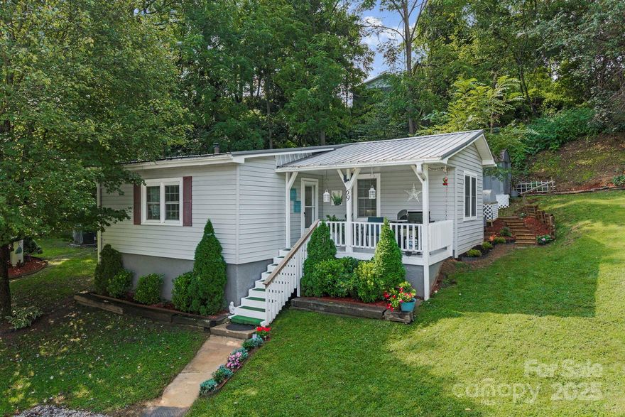 CASH ONLY – ATTENTION CASH BUYERS! Set on a beautiful, well-manicured .49-acre lot, this home offers the perfect blend of peaceful mountain living and small-town convenience. Just minutes from historic downtown Canton’s shops, dining, and festivals—and a short drive to Asheville, Waynesville, and outdoor treasures like Lake Logan and the Blue Ridge Parkway—you’ll enjoy both community charm and easy access to adventure. Step inside and fall in love with the inviting interiors. The living room greets you with striking wood-beam ceilings, abundant natural light through picture windows, and a cozy fireplace that anchors the space. The flow continues into a bright dining area and a beautifully updated kitchen with sleek countertops, white cabinetry, modern lighting, and bar seating—perfect for both everyday living and entertaining. Outside, a large metal storage building doubles as a garage, while a second workshop provides extra space for projects or hobbies. Offered fully furnished, this move-in ready home combines stylish updates, modern functionality, and turnkey convenience—a rare find in the heart of the mountains. This is a mobile home with two site-built additions. The mobile home title has been retired and is now "real property". CASH BUYERS ONLY!