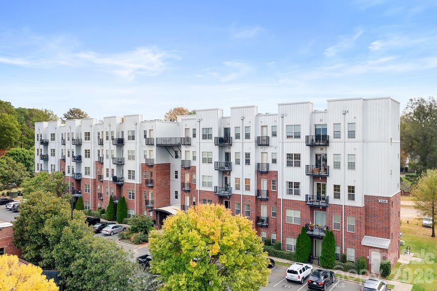 There is so much for you to love about this first floor condo in 28th Row. My favorite is the ease of access to enjoy it all- no elevators or stairs to worry about & this home has a walk-out patio! Enjoy all that NoDa & Villa Heights has to offer- so many restaurants, breweries(one across street), coffee shops, gyms & light rail all close by (see attachment for list). Rhino Market & Free Range Brewery are literally just steps away, across the street.  Why rent when you can have home ownership in this amazing area! Short stroll to Cordelia Park. Side entrance door with green space and doggie station to make walking the dog a breeze. The home has a split bedroom layout & open floorplan w/ceiling fans in each room. 10 -foot ceilings & stained concrete floors throughout. Ample sized bedrooms w/walk in closets, connected baths (granite in one), perfect for roommates. The kitchen features a new induction range (new cookware included), brand new Samsung Bespoke fridge, granite counters, touchless faucet & open concept for entertaining. LG washer & dryer included. Community rooftop terrace w/skyline views. Some photos virtually staged.