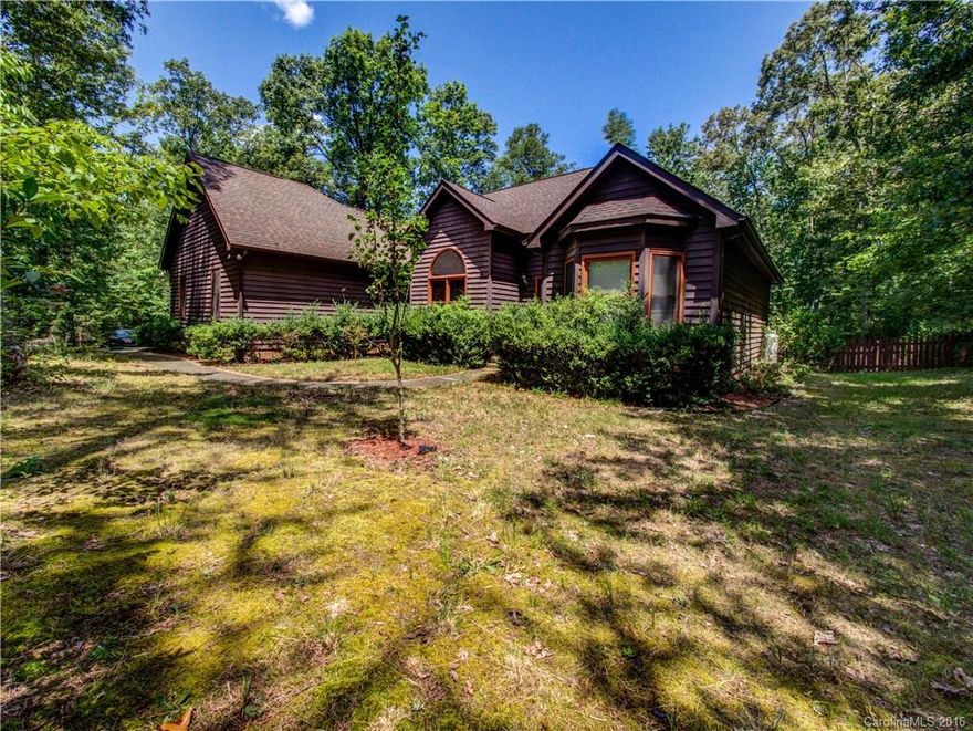 BEAUTIFUL South Charlotte home on large, private wooded lot! Welcoming foyer flows into a spacious great room w cozy fireplace. Open kitchen w breakfast bar, corian countertops & stylish, white cabinets. Relaxing master retreat w en suite, dual vanity, walk-in closet & garden tub. Large widows throughout allow natural light to flow through & show off a beautiful view outside! Private deck including hot tub is perfect for entertaining! Close proximity to Lake Wylie & Fort Mill! No HOA!