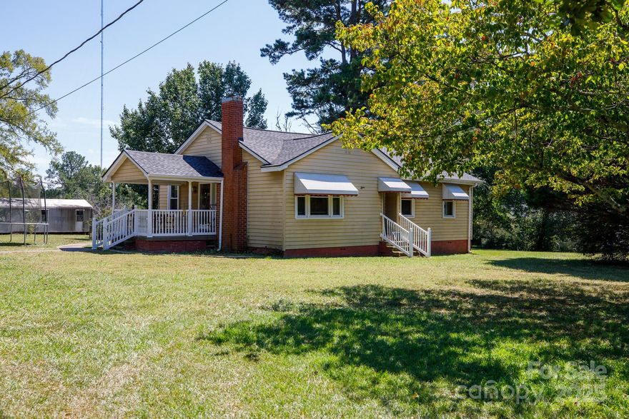 This single-level ranch home in Chester sits on 1.61 acres, offering plenty of outdoor space and potential. A large side porch provides room to relax or entertain, while the detached two-car carport with an attached storage area offers practical parking and extra space. In addition, there are two separate storage sheds on the property for tools, equipment, or hobbies. Inside, the living room features a fireplace as a central focal point. The larger lot and several storage buildings create opportunities for storage, hobbies, or future projects.