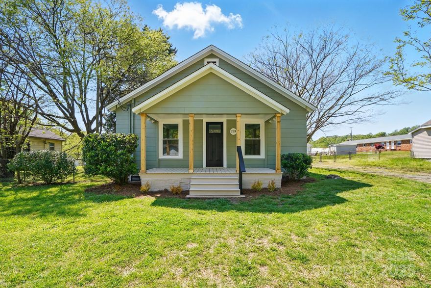 Very cute, remodeled home in convenient location. Appox. 5 min from I-85.  Home is located in the heart of Mount Holly.  Large lot, partially fenced.  Covered front porch.  New gravel in driveway will be put in soon.  Home is quaint and has a lot of character, including built-ins in dining room and small bedroom.  New flooring throughout. Although fireplace is not functional, mantel adds a touch of charm and a place to hang your Christmas stockings.  Kitchen features white cabinets and guartz countertops, new stove and microwave.  Small butcher block in kitchen remains with house.  Seller has installed little shelves for decorative items.  All pulls, knobs and door knobs are black for decorative accent.   Main bath shower tiled with subway tile.  Both baths have new sinks and cabinets.  Back yard is partially fenced.  Large new deck on back; rod iron table and chairs remain with house.  Separate laundry room/mud room on back of house.