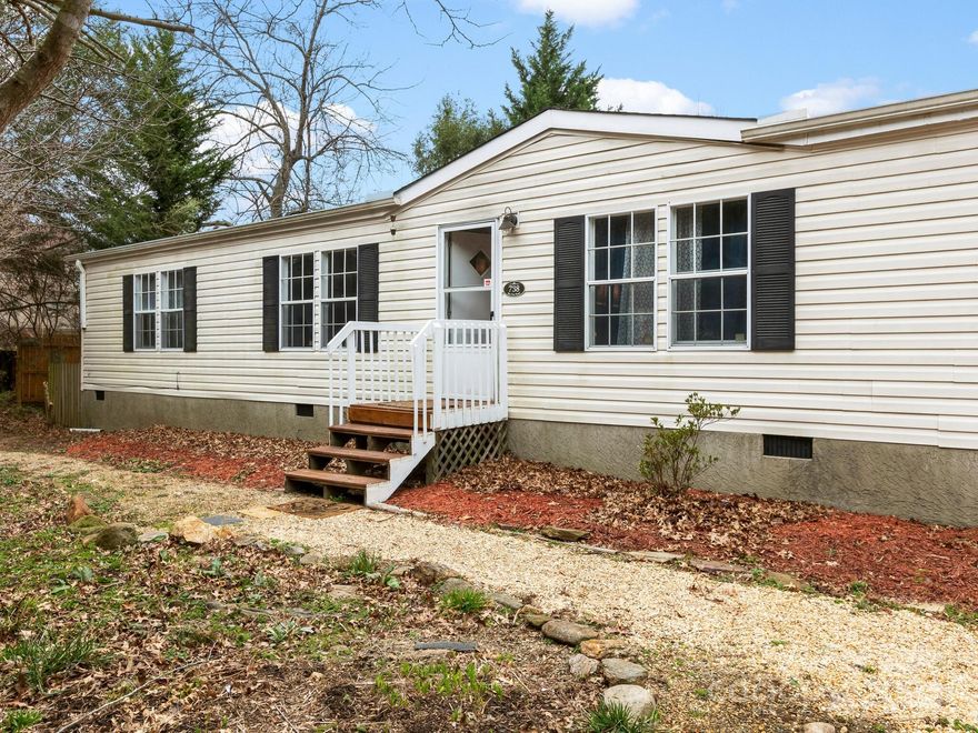 This charming 3-bed, 2-bath home is perfect for hosting guests and creating memories. The open-concept layout and split bedroom design connects a spacious living area with a well-appointed kitchen. Recent improvements include new paint, new floors, new plumbing in the primary bathroom, updated kitchen faucets and new water lines for the washer hook-up. The fenced backyard is a gardener's paradise with ample space for planting and relaxation. The large outbuilding offers extra storage and creative space. Close to Asheville and the Blue Ridge Mountains, this home is perfect for those seeking tranquility and convenience.