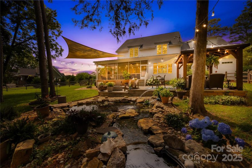 Southern Charm Meets Modern Elegance at 738 Rocky Hollow Trail - Welcome to your dream home, where timeless southern charm and luxurious comfort come together on 1.14 acres of pure serenity. Enjoy sunrises and sunsets from the wraparound or screened porch overlooking beautiful landscaping, mature trees, a koi pond, custom pergola, stone patio with fire pit, and garden beds—all within a fully fenced yard. Inside, 3,500+ sq ft of thoughtfully designed space includes 4–5 bedrooms, 3.5 baths, a gourmet kitchen with granite countertops, gorgeous cabinetry, and a spacious dining area. The main-level primary suite offers a spa-like bath with an oversized walk-in shower, soaking tub, and a dream closet. Upstairs features a split bedroom layout with 3 spacious bedrooms and a bonus room.  Updated 3-car garage with cabinets and polyaspartic flooring! Don’t miss this rare retreat in Clover — known for its top-rated schools and small-town charm!