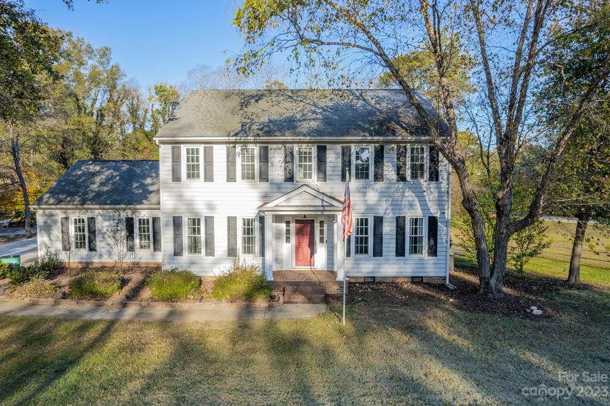 Stunning must see corner lot home w/ no mandatory HOA! Sitting on .94 acres, this home boasts beautiful mature trees & a huge backyard. The welcoming foyer leads to a spacious main level w/ gorgeous crown molding throughout. Formal dining room features decorative wainscoting & chandelier perfect for hosting gatherings. The kitchen features S/S appliances, granite counters, ample cabinet space, & a breakfast area. The great room includes a wood-burning fireplace & built-in bookshelves! Bathroom & laundry complete main level. The owner's suite features awalk-in closets & en-suite bath w/ dual vanity. Secondary bedrooms & bathroom complete upper level. This backyard is an entertainer's dream! Large screened in porch, deck, firepit, & playground! Shed provides extra storage space & features 50 amp service. Great Concord location close to Concord Mills, the speedway, restaurants, schools, & shopping!