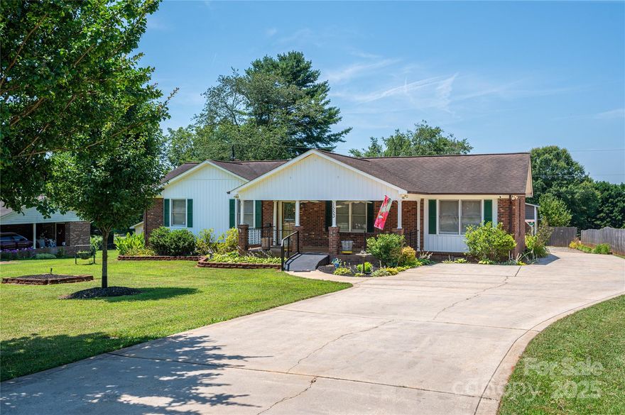 Welcome to this well maintained 3-bedroom, 2.5-bath home located in the quiet & established Whispering Pines community. With a split floorplan, this home offers privacy, making it ideal for a variety of lifestyles. The spacious primary BR includes a full bath & walk-in closet. The open-concept living room, dining area, and kitchen is great for everyday living & entertaining. Down the hall, find two additional bedrooms and a full bath—perfect for family, guests, or a home office. Enjoy the best of outdoor living with a large front porch, a covered back deck, and a sundeck—plus fenced areas that are perfect for your furry friends. The lush, mature landscaping adds curb appeal and is easily maintained thanks to a built-in irrigation system. For those who love to garden, a greenhouse is ready and waiting. A 1.5-story workshop offers a great space for hobbies or storage. Conveniently located near Hwy 321, this home offers an easy commute to Gastonia, Charlotte, Hickory & Maiden.