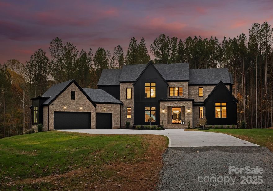 A rare opportunity to own a brand-new custom home on over 8 sprawling, private acres just minutes from Lake Norman & Uptown Charlotte. Designed by renowned architectural firm Smith & Slovik and brought to life by award-winning, woman-owned BAAS Construction, this residence offers a secluded, estate like setting where nature, serenity, and convenience converge. The thoughtfully curated floor plan delivers open concept living with seamless indoor outdoor flow, perfect for entertaining or simply enjoying the quiet beauty of your surroundings. Tucked far off the road and enveloped by trees, this property is a true retreat that offers the best of all worlds; expansive land, ideal location, and the peace of mind that comes with brand new construction.