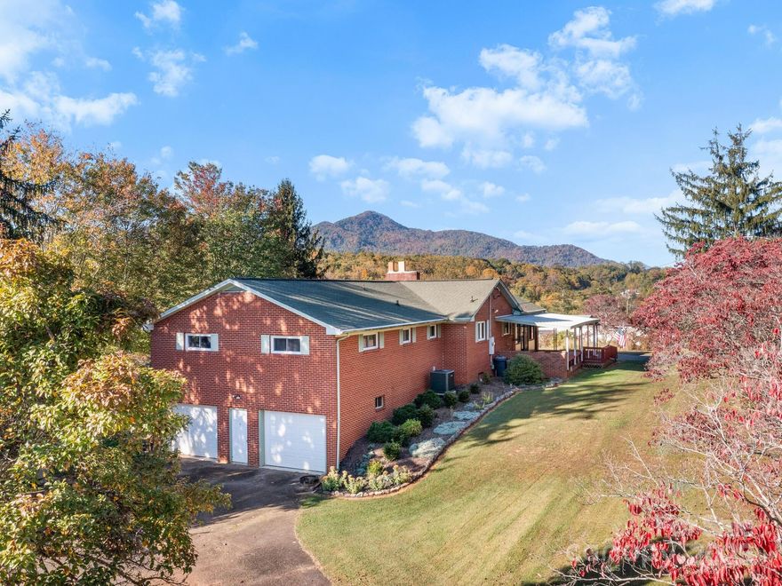 Mountain Views & Space to Grow on 1.95 Acres! This timeless brick home on a full basement offers exceptional mountain views with gently rolling and cleared land. The land presents endless opportunities for additional building or your own mini-farm. The updated kitchen shines with beautiful cabinetry, new appliances and granite countertops. Hardwood floors extend throughout the main level common areas. A cozy brick fireplace with gas logs complements the wood floors. Directly adjacent to the kitchen and dining area is an inviting 4-seasons room with stunning views. There are several outdoor areas to soak up the views including a covered front and side porch. The basement offers a 390 sq ft finished room (not included in total square footage), a large laundry area with sink, full bath and ample storage areas. Also in the basement is a generous two car garage. Additional features include epoxy floors, two driveways, a two-car carport, and plenty of open parking for all your vehicles and hobbies. See the "Updated Features" list for a complete overview of all recent improvements! This home is ready for your personal updates and offers incredible potential in a peaceful setting just minutes from town.