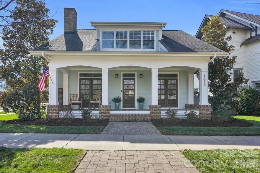 Experience the perfect blend of timeless craftsmanship & modern sophistication in this custom-built Grandfather Homes residence nestled in between the highly sought after neighborhoods of Ashbrook & Sedgefield in an intimate 15-home community just minutes from multiple parks, the 19-mile Little Sugar Creek Greenway/Bike Trail, plus all the restaurants & entertainment in SouthEnd. Designed for both everyday living & effortless entertaining, the main level features an open floor plan with 10-foot ceilings, rich hardwood floors throughout, solid-core 8-foot doors, coffered and trey ceilings, and custom lighting including recessed lights, pendants, sconces, and ceiling fans. A contemporary linear stone fireplace anchors the living room, flanked by custom built-ins by Kauffman Furniture. Interior and exterior ceiling speakers elevate both quiet evenings and lively gatherings. The expansive kitchen is a true showpiece, offering stunning quartz countertops, elongated tile backsplash, custom cabinetry, stainless steel appliances including a wine cooler, gas cooktop with electric oven, striking range hood, & a generous pantry. Whether hosting dinner parties or enjoying a quiet meal at home, this kitchen delivers style and function in equal measure. With three spacious bedrooms, each featuring its own private bath and large closet, comfort and privacy abound. A secondary main-level suite includes a luxurious bath with quarts counters, tub, and custom tiled shower. Upstairs, the primary suite offers trey ceilings, a large walk-in closet with custom built-ins, dual vanities with quartz counters, private water closet, and a massive walk-in shower with digital controls for a true spa-like experience. Two large walk-in attic areas provide exceptional storage. Outdoor living is just as impressive. The fully fenced backyard creates a private retreat complete with lush landscaping, a generous paver patio, built-in gas grill, and even a tucked-away reading nook/deck for peaceful moments. The welcoming front porch invites morning coffee and afternoon drinks with neighbors, embodying the charm of this close-knit community. The neighborhood hosts fun get togethers/events including cookouts in the cut-de-sac! A detached garage offers incredible main-level storage plus its own 500+sf unfinished attic which could be converted to a 4th bedroom/2nd living quarters, bonus room, or home office. Recently updated with modern flair while preserving its craftsman character, this home seamlessly combines thoughtful design, premium finishes, and an unbeatable location. Less than 1 mile to Freedom Park & Park Road Shopping Center. This is more than a home—it’s a lifestyle.