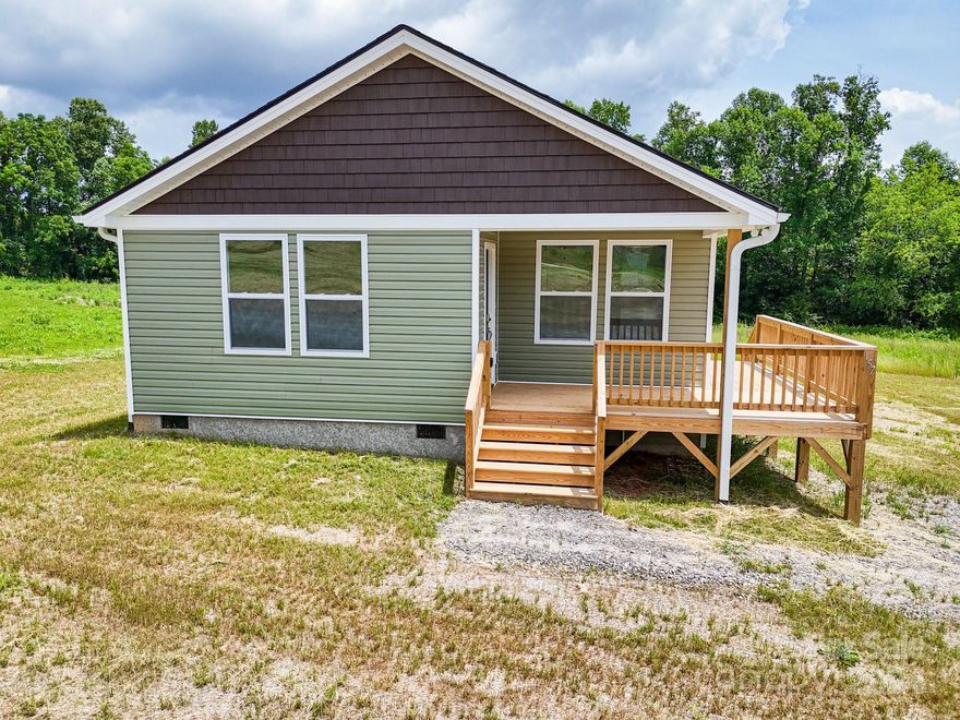 Bellflower Meadows is a 16 lot subdivision in the heart of Apple Country. Minutes to your favorite fall hay ride and apple picking. Less than 10 minutes to grocery stores and restaurants and only 15 minutes from downtown Hendersonville. Big flat yard! Open floor plan bathed with warm natural light is perfect for entertaining. Roomy primary bedroom boasts a large walk-in closet and primary bath with dual vanity and custom tile shower. Luxury vinyl plank flooring, fabulous kitchen with stainless steel appliances, granite counters, spacious all-plywood soft close cabinets, under cabinet lighting, and the perfect kitchen island. Neutral colors make decorating a breeze. A spectacular place to enjoy that clean mountain air. Well-priced, move-in ready and waiting hold all of your fond memories or become your next charming retreat or sought after investment property. Finished interior pictures are shown as an example. Tax value based on previous vacant land does not represent improvements.