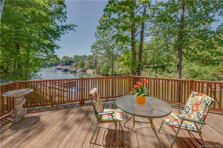 Light & airy lake home charms w/great WF views inside & out. Screen Porch, Upper Deck & Lower Cov Deck. Quiet Cove w/Shade tree privacy & deeded slip/jetski ramp in view nearby.  HW floors, Wood ceiling w/Exposed Trusses, Open concept Dining, Kit & GR. Stacked Stone Wood-burning FP. SS appls. Eat-in bar.  Main level Master + Walk-out Bsment w/2nd Master or Rec Rm, Full Bath, Bonus Rm & Storage! Upper Loft + 2 BRs & Bath.  Bath fixtures/tile flooring updates. Roof-2013. Mins to LKN State Park.