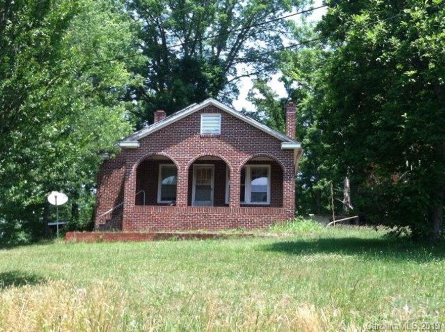 Beautiful brick arched front porch. Mountain views. 7.3 acres. Sold as-is. Adjoining property available. Priced to sell at tax value. New roof coming this summer!