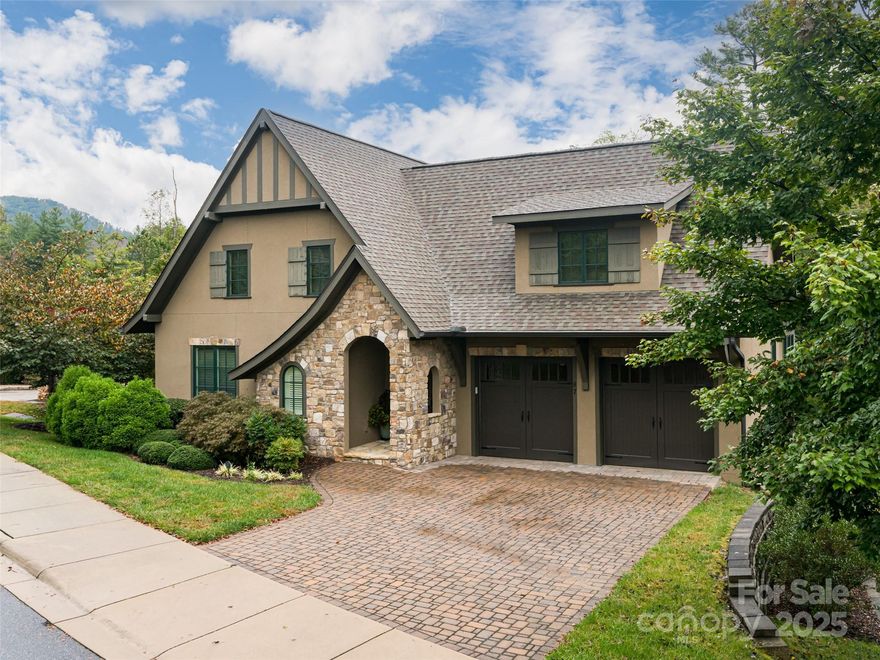 A picturesque setting envelops this European style cottage with a lovely, private corner lot. So many special features make this like new home one of true luxury. From the moment you enter the front door your gaze is drawn upward to the brick barrel vaulted ceiling. Appropriate to its style, the home is filled with thoughtful built-ins, high end finishes and cabinetry, with a floor plan designed for comfortable yet elegant living and outdoor spaces to use for entertainment or private enjoyment. The kitchen features a gas range with a griddle and just outside on the breezy screened porch you will find a built in grill. The kitchen cabinetry features glass door cabinets and a backsplash accented with metal tiles. The main floor laundry room has cabinets worthy of a high end kitchen. A calming color palette creates a serene environment for art or music or reading. The spacious primary bedroom features a walk in closet that is extensively outfitted. Downstairs offers a recreation room with built-ins and wet bar. The beauty of this home is more than skin deep. It extends to thoughtful features like a conditioned crawl space and more.