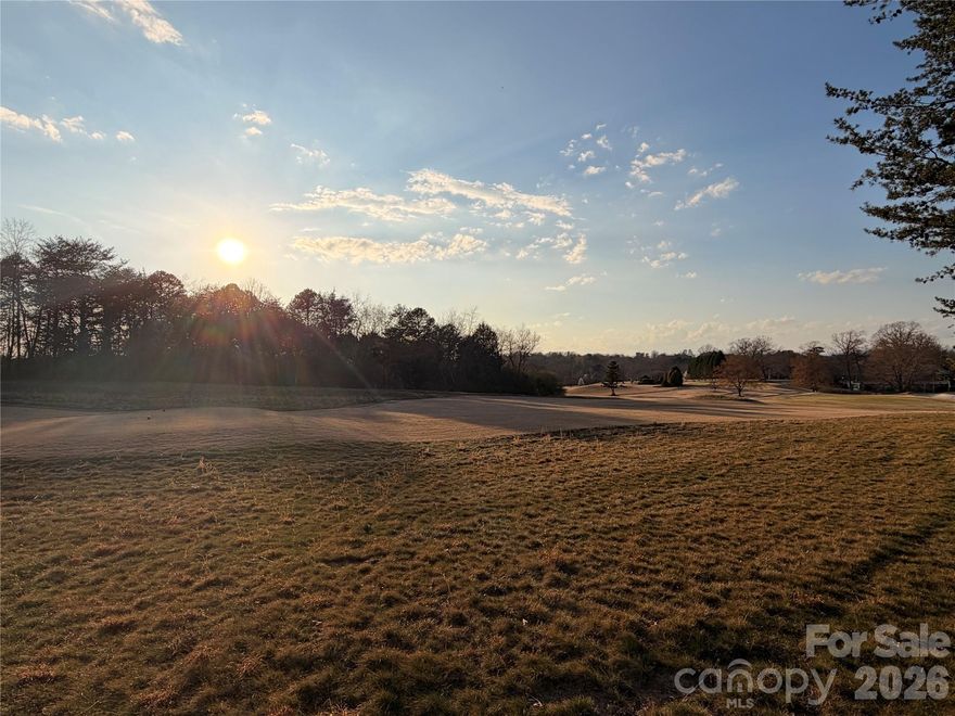 This incredible .64 acre,  9th tee-facing, lot sits directly along the green at Lake Hickory Country Club’s Catawba Springs course, offering daily front-row views of one of Hickory’s premier private golf facilities.  Tucked into the established Catawba Springs Golf Community in northeast Hickory, the lot combines a peaceful residential feel with the convenience of being inside the city limits and just minutes from shopping, dining, and major roads.

Wake up to manicured fairways, mature trees, and the quiet rhythm of play unfolding just beyond your backyard as golfers tee up on the 9th hole. Instead of driving to find green space, you can enjoy your morning coffee on a future patio or screened porch while watching golfers approach the turn and admire beautiful sunsets over the course. Evening walks follow tree-lined streets where many homes are positioned to take advantage of golf views, creating a neighborhood atmosphere that feels relaxed, social, and connected to the outdoors.

Life here is centered around Lake Hickory Country Club, which operates two facilities and describes itself as the premier private country club in Hickory with a “best in class” experience across golf, tennis, fitness, dining, and social amenities. At the Catawba Springs campus, members enjoy 27 holes of private golf, a full practice facility, and a clubhouse that serves as a social hub for dining, drinks, and events. Food and beverage service includes bar, grill, and restaurant offerings, and the club also provides meeting and banquet facilities for gatherings, celebrations, and special occasions.

Beyond the course, active living is supported by additional club amenities such as tennis, fitness, and organized programs for members. The club’s fitness center features aerobic machines, free weights, an indoor racquetball court with viewing area, men’s and ladies’ locker rooms, and steam or sauna facilities, along with classes like spin, yoga, and conditioning to make wellness a natural part of your weekly routine. Tennis and pickleball options, along with social events and junior activities, round out a lifestyle where it is easy to stay engaged without leaving the community.

Catawba Springs is governed by recorded bylaws and covenants administered by the property owners association, which are designed to preserve the neighborhood’s appearance and protect long-term property values. Owners planning to build or add improvements must also follow the City of Hickory’s land development and building regulations, with the more restrictive of the city or community rules applying, helping to maintain a cohesive streetscape and a well-kept environment around the golf course. Nearby golf community listings highlight city water, sewer, trash, and street lights, along with wired connectivity options, underscoring the blend of resort-style setting and practical everyday infrastructure in this part of Catawba Springs.

With its direct hole frontage, private-club setting, and access to a full slate of country club amenities, this lot offers an ideal opportunity to design a custom home that feels like a year-round getaway—whether you are hosting friends after a casual round, watching the last group finish as the sun goes down, or simply enjoying the quiet beauty of living right on the golf course.