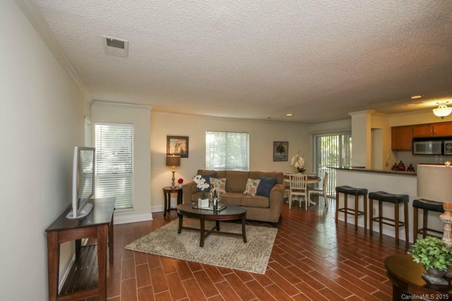 JUST REDUCED $10,000 and is priced to sell!  This luxurious condominium is located just minutes from Uptown. Wake up and have your morning coffee hearing the birds chirping on the private balcony or come home from work and stroll down the tree lined streets in the beautiful Eastover neighborhood. 2 spacious bedrooms and 2 baths,  it is upgraded with all the current finishes~wood grain tile floors, granite and cabinetry.  All that and you have the convenience of being located on the ground floor!