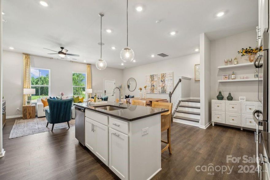 MLS#4207977  REPRESENTATIVE PHOTOS ADDED. March Completion! The Aspen at The Ridge at Sugar Creek is a thoughtfully designed two-story townhome in Indian Land, SC, combining style and convenience. The main floor features a welcoming owner’s entry from the rear 2-car garage, leading to an open-concept kitchen with a walk-in pantry and a casual dining area. At the front of the home, a spacious gathering room offers the perfect spot to relax, while a convenient half bath adds practicality. Upstairs, a bright loft provides a great space for game nights or lounging. The second floor also includes three bedrooms, a secondary bath, and a centrally located laundry room. The deluxe owner's suite impresses with two walk-in closets, a spa-inspired bath with dual sinks, and a beautifully designed shower enclosure. Design options added include: 30" gas range.