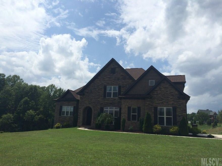 This beautiful home is located in desirable mountain view in Howards reach subdivision a walk in distance from mountain view elementary school, one of the top schools in Catawba county. (builders personal home). Quality brick & stone exterior with covered deck that overlooks the pond next door and Bakers mountain. House has 4 car garage, 4 bedrooms 1 teen loft 1 bonus room and 3 1/2 bath. Foyer opens to both formal dining with coffered ceiling and family room with pine rustic beams and stone fireplace. Master suite with cathedral ceilings on main level. Master bath has walk in shower his & hers vanities and jetted tub. Kitchen has custom cabinets with self closing hinges & gliders stainless steel appliances granite tops induction cooktop cooper sink and pantry. Upstairs 2 bedrooms with tray ceilings & walk in closets a teen loft one large bonus room and 1 1/2 baths.Hardwood floors throughout and natural stone for bathrooms & laundry, central vacuum system,wireless alarm system ADT.