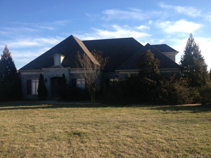 Large home with lots of potential just over the Cabarrus County line.  Water view.  Large great room with built-ins and beamed ceiling, 2 master closets (1 with hidden safe room), dramatic ceiling in master bedroom, large kitchen with custom cabinets, huge upstairs bonus with private bath.  3 bedrooms down and bedroom/bonus with private bath up.  Outdoor living area with fireplace overlooks water.  Great investment!