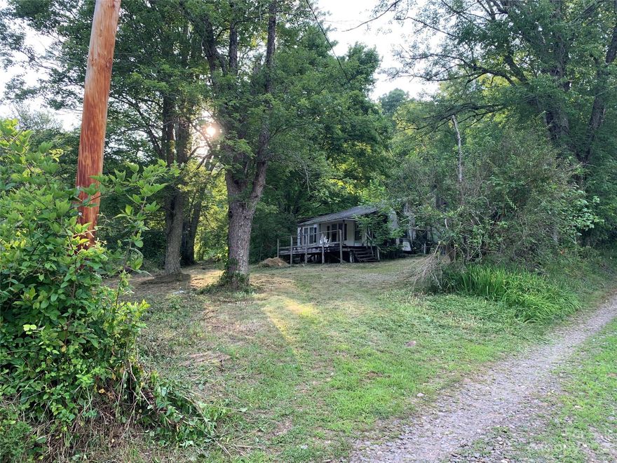 Conveniently located in west Yancey this nearly level lot consists of +/-1.5 acres just off the state maintained Horton Creek Rd. Only 30 minutes to Asheville and 10 minutes to downtown Burnsville or Mars Hill. Would be an easy fix for RV/camper site or tiny home and is bordered by small creek that runs year round. Old home on property of no value-being SOLD AS IS and may be unsafe to enter.  Soil scientist recommended by county in order to install new septic system-. Do NOT enter property unless accompanied by agent- due to open test pits for septic (which are marked with orange flags). Deeded water rights to spring on neighboring property-seller has no knowledge about location. This one will go fast- schedule your showing today!