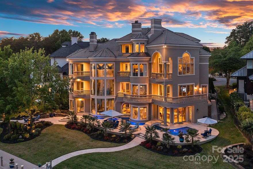 Experience the luxury of waterfront living in this breathtaking gated Mediterranean estate. Unbeatable views of Lake Norman welcome you through floor to ceiling curved glass windows and into expansive transitional living areas. A true chefs kitchen with high-end appliances, Miele coffee system and butler's pantry, ideal for both intimate and lavish entertaining. The two-story primary suite is a private sanctuary featuring a dedicated office, sitting room with a 2 sided fireplace, spa-like bath with dual vanities, his and her water closets, soaking tub, oversized glass shower, gym, 2nd laundry, sauna, and steam shower. The lower level is an entertainer’s paradise, complete with a guest bed/bath, a Full Swing golf simulator, kitchenette, billiards and temp-controlled wine room. Outside, the resort-style oasis includes a heated saltwater pool, swim-up bar, lush landscaping, private boardwalk, pier and dock ensuring relaxation and enjoyment year-round. Offered fully furnished.