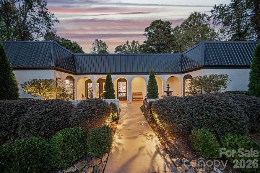 Welcome to a truly rare offering in the heart of Hickory — a residence rich in character, history, and timeless appeal, now presented with a substantial price improvement and the added benefit of an adjoining 1.25-acre lot that conveys with the property. Whether you choose to build, hold, or sell, this additional parcel creates exceptional flexibility and long-term value seldom found in an in-town setting.

Known as The Lavitt Legacy Estate, this historically significant home was originally built by Paul and Pauline Lavitt, founders of Paul Lavitt Mills, whose company became a cornerstone of North Carolina’s textile and legwear industry. Their legacy of craftsmanship, innovation, and community leadership is reflected throughout the home, which stands today as a beautiful bridge between Hickory’s storied past and the comforts of modern living.

Set across approximately 2.5 total acres including the additional lot, the property offers a private estate atmosphere within one of Hickory’s most desirable districts. Mature hardwoods, thoughtfully designed gardens, and a graceful blend of classic architecture with modern updates create a setting that feels both refined and welcoming.

Inside, the renovation carefully preserves original character while introducing contemporary functionality. Updated bathrooms feature high-end finishes with period-inspired touches, including a distinctive custom barbershop space that adds charm and personality. The light-filled kitchen and living areas showcase restored hardwood floors, updated lighting, and upgraded electrical and plumbing systems. Modern enhancements such as a whole-house water filtration system, tankless water heaters, and a Level 2 EV charger provide comfort and efficiency for today’s lifestyle.

The grounds were reimagined by Linda Greenberg Landscape & Design, resulting in a sophisticated outdoor environment with curated plantings, raised garden beds, smart irrigation, and year-round visual interest — perfectly complementing the home’s historic presence.

This is more than a residence; it is a meaningful piece of Hickory’s heritage thoughtfully updated for modern living. With close proximity to downtown, medical facilities, and cultural amenities, the estate offers a rare combination of privacy, history, and convenience — an exceptional opportunity for buyers seeking authenticity without compromise.

Select furnishings and artwork are available for purchase.