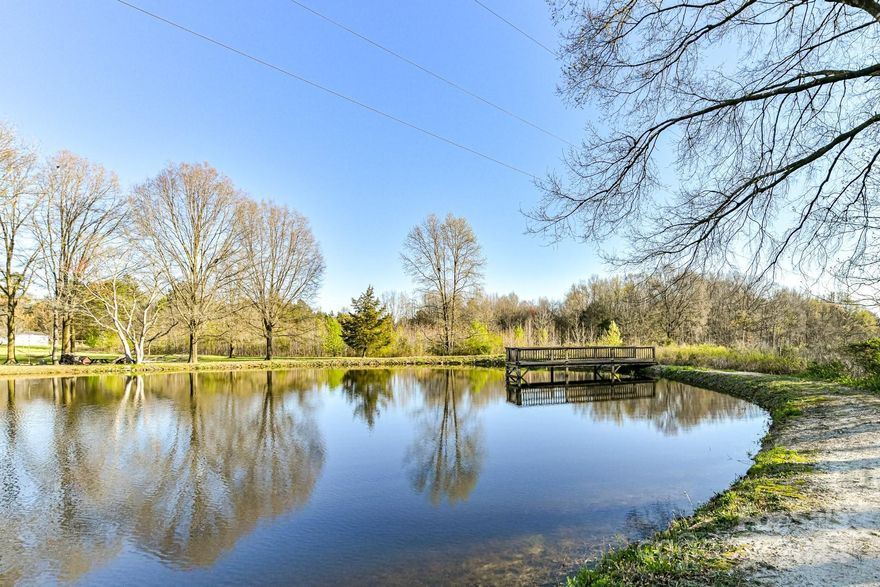 Welcome to this serene oasis nestled on one of the highest hills in Union County and close to 30 acres of peaceful and picturesque land offering tranquility and natural beauty. Plenty of room for horses! The property features a barn and storage sheds, perfect for hobbyists or those seeking additional storage space. Enough land for the outdoor enthusiasts to enjoy their dirt bikes, ATV's etc. Live in the spacious existing home or find your unique spot on the land to build your dream home. Further development opportunities on the expansive grounds is a possibility. (Additional perc sites have been found previously). Relax on the charming front porch overlooking a private pond, surrounded by lush wooded areas and open clearings. With three bedrooms, two baths, and an inviting open floor plan, this home provides the ideal setting for relaxation and gatherings especially in the 22'x22' SUNROOM. Embrace the possibility of creating your own haven amidst this beautiful landscape.