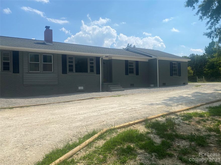 Home completely renovated.  Freshly painted, hardwood floors refinished, new LVT, light fixtures. Roof extended on back for storage of landscaping equipment, bikes or ATV's. Lot is 7.2 acres with open area and a pond. Partial fencing at rear.  Owner would allow tenant to install fencing for horse. No Smoking in home.  No inside pets. allowed. Located approximately 7 miles from Waxhaw.