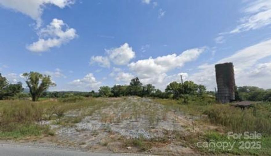 This rare flexible investment opportunity is located in the desirable Asheville, NC submarket, Mills River, NC. This +/- 20 acre property is zoned General Business (MR-GB) and has on-site Sewer, Electric, and Water. Over 900' of frontage on high trafficked Haywood Rd (NC 191) that's expanding to a 5-lane Highway in the near future (+/-0.749 acres reduction on lot), from the Intersection of NC-191 & NC-280 with a combined daily traffic volume of over 30k AADT. Zoned as general business with potential for versatile use (MR-GB), this could be ideal for self-storage, general commercial, retail, medical office, and mixed use pending an engineer survey and city zoning approvals. +/- 7 acres filled and rough graded, +/- 10 acres fillable for further development, +/-3 acres located in floodway, 320" of river frontage on Mills River. Approx. 19 miles from downtown Asheville, NC. Approximately 8 miles to downtown Hendersonville, NC. Visit https://vitalcre.com/4165-haywood-road for details.