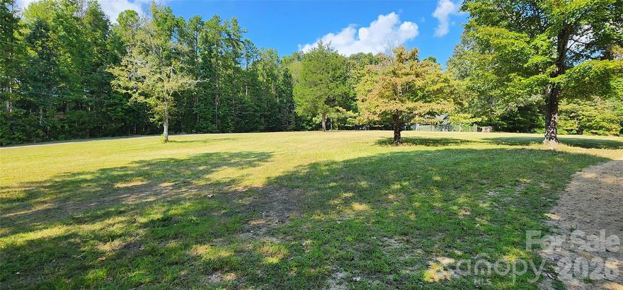 Experience "The Oasis in Indian Land", where Luxury Meets the Rural Lifestyle. Discover over 22 acres of privacy and natural beauty at The Oasis, this one of a kind, hard to find rural retreat designed for both relaxation and adventure. This single owner custom estate home features 4 bedrooms, main level primary bedroom, 2.5 bathrooms, 3 car garage, in ground salt water pool, hot tub and a fenced in backyard. Enjoy the outdoors with ATV, hiking and equestrian trails, deer and turkey hunting, a flowing creek and a garden ready for farm-to-table living. There is a storage shed, brand new roof, 2 newer HVAC systems with service contracts in place to provide peach of mind, home inspection report is available by request. There is plenty of room for your family compound if you need more than 1 home, barns or additional building sites with potential equestrian pasture to round out your rural retreat. This property  is perfectly located about 10 minutes from shopping and dining in Waxhaw NC, Indian Land SC and a few more minutes to Ballantyne, Fort Mill, Rock Hill or Charlotte. The NC or SC coast is about 3.5 hours and the mountains are about 2.5 hours away for those quick weekend trips.