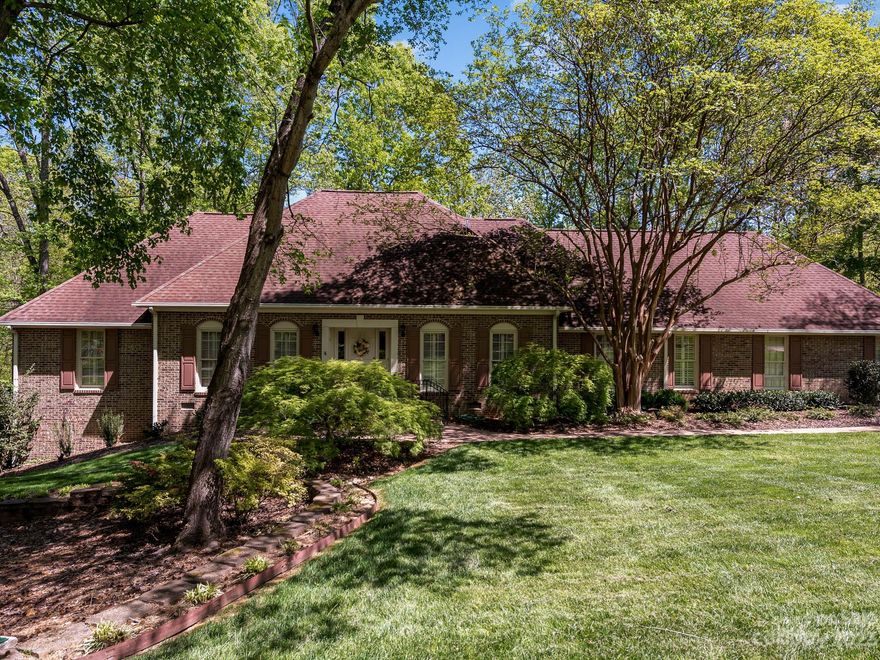 Opportunity awaits in this exquisite home w/updated kitchen & 2 of 3 full baths totally renovated! So much is already tastefully done in this home. Kitchen has wood floors, granite, SS appliances, small island, breakfast bar w/seating. Large laundry room w/lots of storage. Huge dining area open to kitchen, then open to marvelous sunroom on rear of house, overlooking woods. Front of house has great room connected to flex room (sitting room or office w/a view?). Lots of pretty molding. 5 bedrooms, 3 down & 2 up. Very spacious primary BR on main w/large walk-in closet & ensuite BA. Outdoor front of home is parklike setting, beautifully landscaped. 3 car oversized side load garage w/tons of cabinets and counters & heated and cooled. On rear, updated deck w/amazing views of woods. Stamped concrete patio below. Lots of room for outdoor living! Below sunroom is room w/HVAC & secondary kitchen area set up for entertaining. This is the one for you!