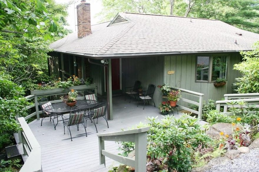 Your Personal Oasis.  A perfect combination of seclusion and great neighbors.  Five minutes to charming downtown Black Mountain with its shops and restaurants. Three minutes to I-40 and Ingles supermarket, and 20 minutes to downtown Asheville.  Well maintained home with a beautiful mountain view and plenty of natural light.  Approximately 2200 square feet with 3BR/2B on two accessible levels including a large den/office.  Sun room  with vaulted ceiling and full-lenght windows.  Open floor plan.  Quartz countertop in kitchen.  Wood burning fireplace insert.  Walk-in shower.  Oversized one car garage with large work space.  Spacious Trex front and back decks.  New roof 2022; new HVAC 2022.  Updated in 2015.  Plenty of parking.  New owner will have access to hiking trails, community pool and playground at Christmount community.