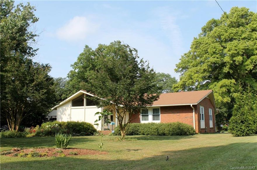Spacious lot with a super-charming 4-side brick home, featuring living room w/vaulted ceilings, exposed wood beams & vintage chandelier, built-in brick planter, real knotty pine cabinets, vintage extra-wide stove w/warming oven, wood floors in BRs and under LR carpet, updated bathrooms, ceiling fans in all BRs and Kit., MB w/large walk-in closet/dressing room/office w/built-in wood shelves, covered gutters, large covered side patio/carport, fenced backyard, wired workshop wood shed, compost area