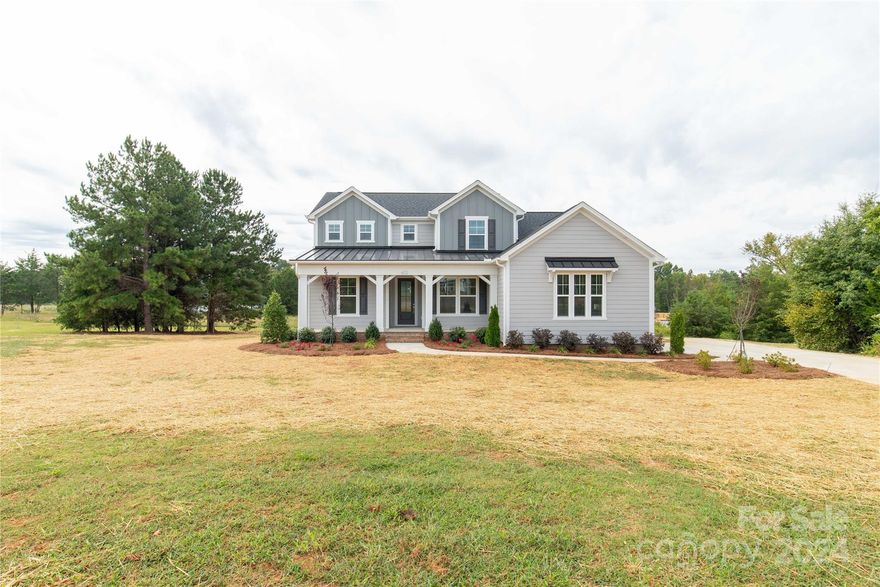 This new construction is located on a 1-acre lot on a cul-de-sac street. The 1st floor features a Primary suite with a private door to a screened back porch, overlooking a spacious backyard. The primary bath includes a frameless glass shower, a large walk-in closet, and convenient bath-to-laundry access. There is a guest room with a full bath on the 1st floor. The stunning kitchen comes with upgraded white cabinets, a large Maple Rye stained island with sparkling white quartz countertops, and a spacious walk-in pantry. The kitchen also includes a butler's pantry and opens to a large great room, which features a gas fireplace, coffered ceiling, and access to the rear porch. There's even a formal dining room that can also function as an office. Upstairs, you'll find a sprawling 26'x16' loft and 2 additional bedrooms connected by a shared bath with private vanities. This home is located in the Clover School District. Builder offering up to 10k in concessions with a full-price offer.